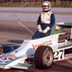 Janet Guthrie poses with an Indy car at Ontario Motor Speedway, 1977